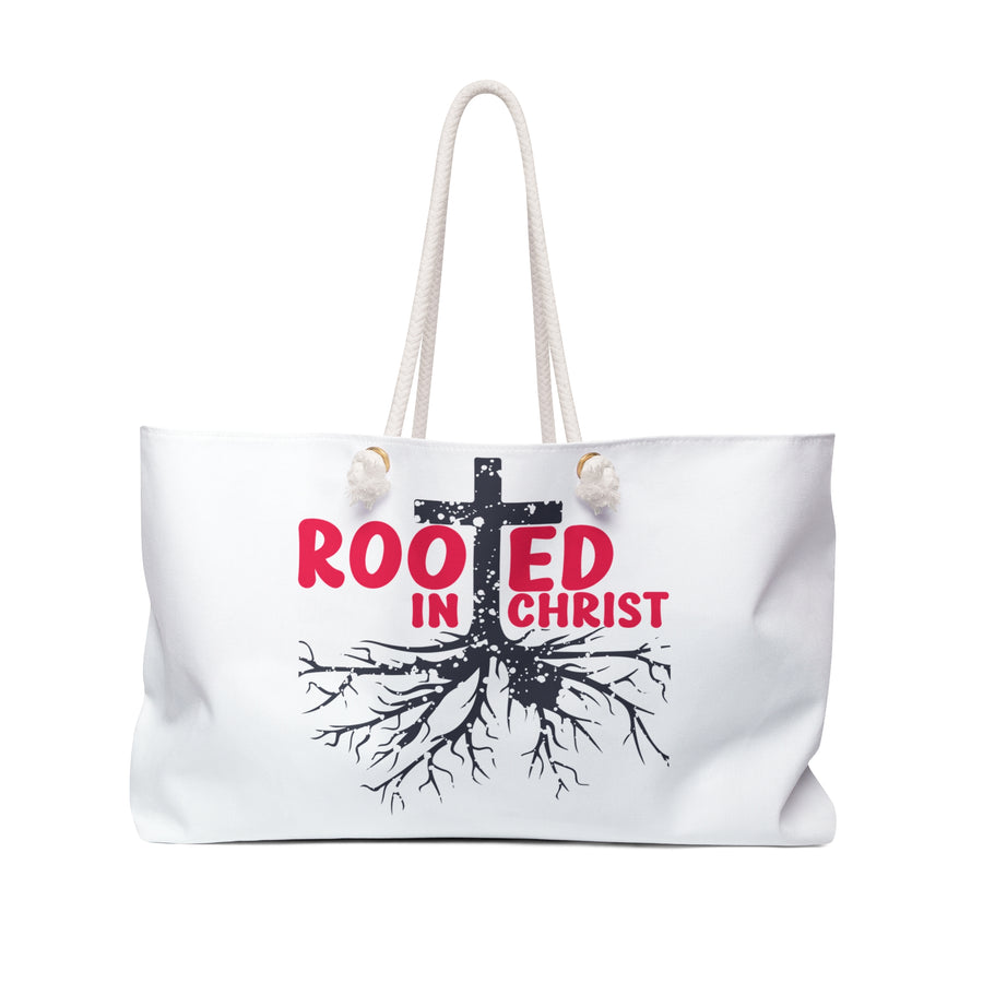 White tote bag with 'Rooted in Christ' design on a white background